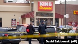 Police stand outside a King Soopers grocery store where a shooting took place, Monday, March 22, 2021, in Boulder, Colo. (AP Photo/David Zalubowski)