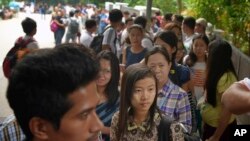 FILE - Myanmar citizens wait for their turn outside the Myanmar Embassy in Singapore to cast advance ballots in the country's Nov. 8 general election, Oct. 18, 2015. 