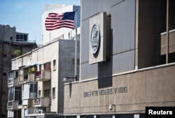 FILE - A flag flutters outside the U.S. embassy in Tel Aviv August 4, 2013.