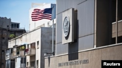 FILE - An American flag flutters outside the U.S. embassy in Tel Aviv, Israel, August 4, 2013.