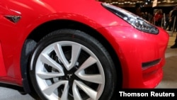 FILE PHOTO: A Tesla Model 3 electric vehicle is displayed at the Canadian International Auto Show in Toronto