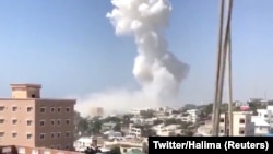 Smoke rises after an explosion in Mogadishu, Somalia, Dec. 22, 2018, in this still image taken from social media video.