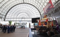 Japan's Chief Cabinet Secretary Yoshihide Suga (C) inspects the G-20 leaders summit meeting venue, INTEX Osaka, in Osaka, Japan, June 22, 2019.