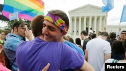 Gay rights supporters celebrate after the U.S. Supreme Court ruled that the U.S. Constitution provides same-sex couples the right to marry, outside the Supreme Court building in Washington, June 26, 2015.