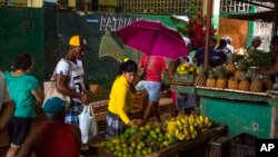 FILE - People shop at the El Egido food market in Havana, Cuba, Dec. 4, 2015.