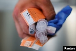 A Cataldo Ambulance medic holds used doses of naloxone after medics revived a man in his 40's who was found unresponsive from an opioid overdose in the Boston suburb of Salem, Massachusetts, Aug. 9, 2017.