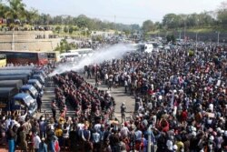 Police fire a water cannon at protesters demonstrating against the coup and demanding the release of elected leader Aung San Suu Kyi, in Naypyitaw, Myanmar, February 8, 2021.