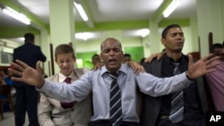 Members of God's Assembly attend a Pentecostal service in September 2014.