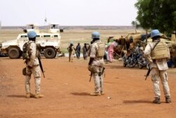 FILE - Senegalese soldiers of the UN peacekeeping mission in Mali (MINUSMA) patrol on foot in the streets of Gao, a day after an attack on an international peace-keeping base in Mali.