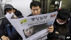  FILE - A South Korean man reads a newspaper with the headline reporting North Korea's rocket launch while traveling on a subway in Seoul, South Korea, Dec. 13, 2012.