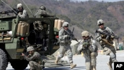 FILE - U.S. Army soldiers from the 25th Infantry Division's 2nd Stryker Brigade Combat Team and South Korean soldiers take part in an annual joint military exercise at the Rodriquez Multi-Purpose Range Complex in Pocheon, north of Seoul, South Korea, Marc