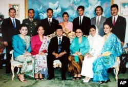 FILE - Hutomo Mandala Putra, popularly known as "Tommy", top row third from left, youngest son of former Indonesian President Suharto, bottom row third left, is pictured in this undated family photo in Jakarta, Indonesia.
