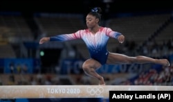 FILE - Simone Biles, of the United States, performs on the balance beam during the artistic gymnastics women's apparatus final at the 2020 Summer Olympics, Tuesday, Aug. 3, 2021, in Tokyo, Japan. (AP Photo/Ashley Landis)