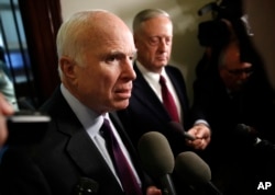 FILE - Sen. John McCain, R-Ariz., left, and Defense Secretary James Mattis speak to reporters after their meeting on Capitol Hill in Washington, Oct. 20, 2017.