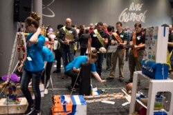 Syracuse Junior High School Mesa Club from Syracuse, Utah shows how their machine "A Day in the Life of a Student" completes the task of applying a BAND-AID bandage at the Rube Goldberg Machine Contest, 2017.