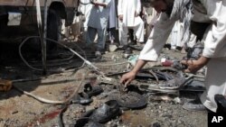 A man collects parts of a damaged bus which was hit by a remote control bomb on the outskirts of Kabul, Afghanistan, August 7, 2012.