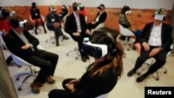 Participants attend the 'Collisions. A Virtual Reality World Premiere' event at the annual meeting of the World Economic Forum (WEF) in Davos, Switzerland January 21, 2016.