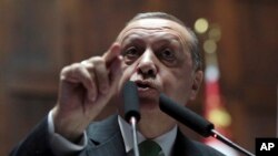 Turkey's President Recep Tayyip Erdogan addresses lawmakers at the parliament in Ankara, Turkey, Jan. 16, 2018. (AP Photo/Burhan Ozbilici)