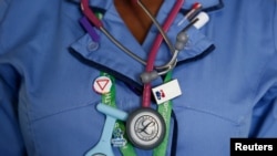 FILE - A nurse wears a watch and stethoscope at St Thomas' Hospital in central London, Jan. 28, 2015. 