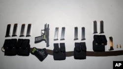 This undated photo provided by the Santa Clara County Sheriff's Office shows guns and ammunition magazines found at the residence of Samuel Cassidy, the suspect in the May 26, 2021, shooting at a San Jose, California, rail station.
