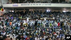 People attend a prayer service led by Mahmoud Dicko, an imam who helped lead the opposition protests, for those who died or were injured during the protests, in Bamako, Mali, Aug. 28, 2020. 