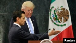 FILE - Then-presidential nominee Donald Trump and Mexico's President Enrique Pena Nieto arrive for a press conference at the Los Pinos residence in Mexico City, Mexico, Aug. 31, 2016.