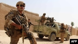 Afghan National Army commandos take position during a military operation in Helmand province, Oct. 2, 2016.