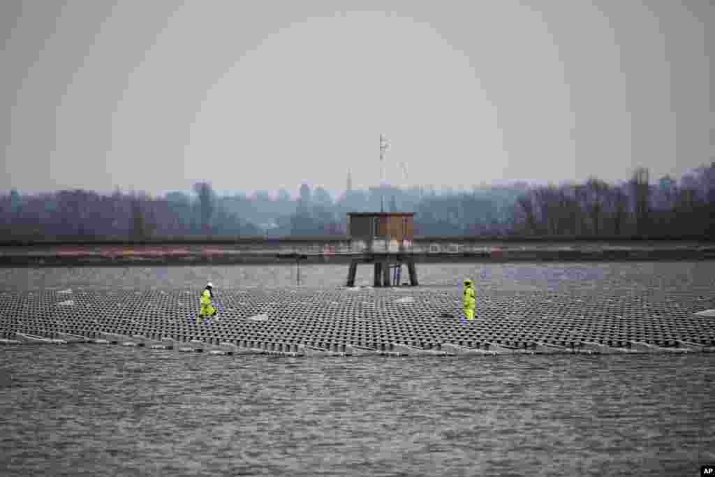Contractors continue work on Europe's biggest floating solar panel array as it nears completion on the Queen Elizabeth II Reservoir near Walton-on-Thames in south west London.