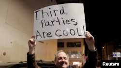 FILE - Libertarian Jeff Jared of Kirkland, Washington, holds a sign in support of third parties in Seattle, Jan. 31, 2019.