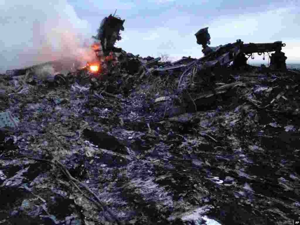 Smoke rises up at a crash site of a passenger plane, near the village of Grabovo, Ukraine.