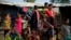 Rohingya Muslims, who crossed over from Myanmar into Bangladesh, wait to collect aid at Kutupalong refugee camp in Ukhiya, Bangladesh, Dec. 21, 2017. 