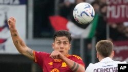 Paulo Dybala de Roma y Michel Aebischer de Bolonia saltan por el balón durante el partido de fútbol de la Serie A italiana entre Roma y Bolonia en el Estadio Olímpico de Roma, el lunes 22 de abril de 2024.
