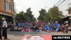 People take part in a sit-in protest in Mandalay, Myanmar, March 10, 2021, in this picture obtained by Reuters from social media.