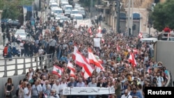 Demonstrators walk on the street during a protest in Beirut, Lebanon, Oct. 31, 2019. 