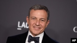 FILE - Disney CEO Bob Iger, pictured in October 2016 at a Los Angeles gala, has served in an advisory role for President Barack Obama and will do the same for Donald Trump when he assumes the presidency. 