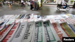 State-run newspapers are displayed for sale on a street in Hanoi, Vietnam, September 26, 2015. 
