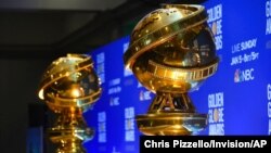 FILE - Replicas of Golden Globe statues are seen at the nominations for the 77th annual Golden Globe Awards in Beverly Hills, Calif., Dec. 9, 2019.