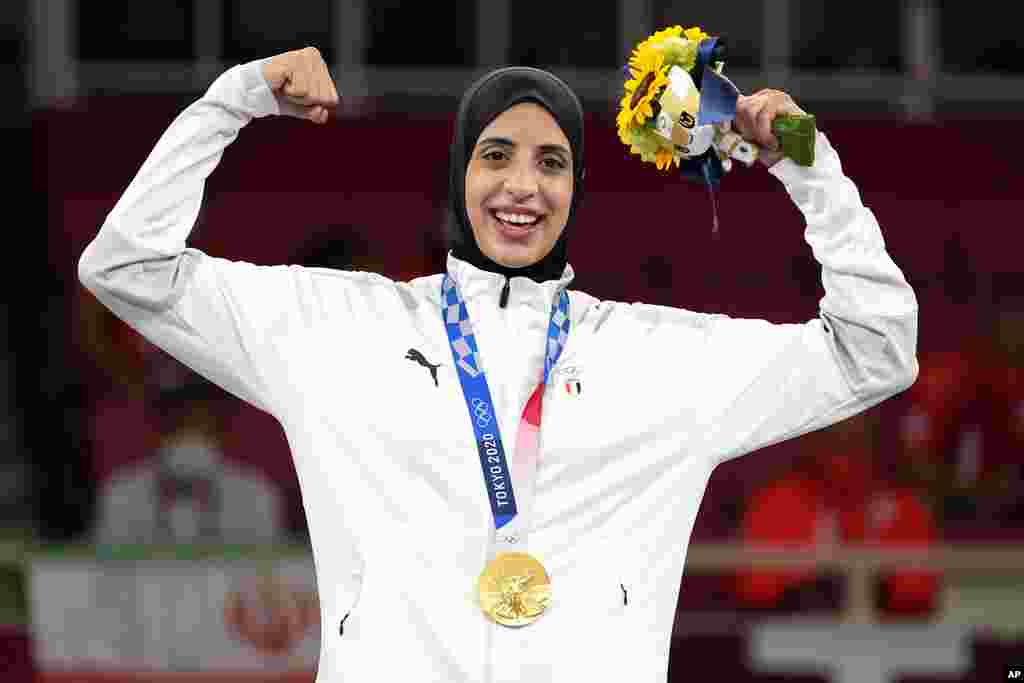 Gold medalist Feryal Abdelaziz of Egypt poses during the medal ceremony for women's kumite +61kg karate at the 2020 Summer Olympics, Saturday, Aug. 7, 2021, in Tokyo, Japan. (AP Photo/Vincent Thian)