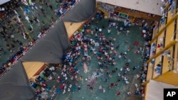 Inmates gather around the corpses of other inmates during a prison riot in Miguel Castro Castro prison, in Lima, Peru, April 27, 2020. 