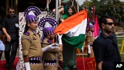 Jammu and Kashmir state Chief Minister Mehbooba Mufti, holds India's national flag after it fell during the unfurling ceremony on India's Independence Day in Srinagar, Indian controlled Kashmir, Monday, Aug. 15, 2016. 