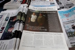 FILE - The final issue of The Cambodia Daily is sold at a newsstand, in Phnom Penh, Cambodia, Monday, Sept. 4, 2017. When Cambodia’s main opposition leader was arrested over the weekend in a surprise police raid, one of this country’s last independent media outlets rushed reporters out in the middle of the night to cover the story, just as it has done for nearly a quarter-century. But the English-language Cambodia’s Daily’s reportage about the arrest of Kem Sokha, who stands accused by the government of treason, was a tragic story in and of itself: It was on the front page of the paper’s final issue Monday. (AP Photo/Heng Sinith)