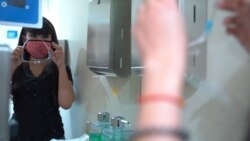 A masseuse, Patnaree Tawang wearing a face mask and protective face shield during her work at the Massage Place in Los Angeles, CA.