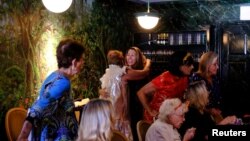 Sylvia Baer finally gets to hug and meet for lunch with other seniors weeks after receiving the coronavirus disease (COVID-19) vaccine in Fort Lauderdale, Florida, U.S., March 5, 2021. (REUTERS/Maria Alejandra Cardona)