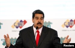 FILE - Venezuela's re-elected President Nicolas Maduro gestures after he received a certificate given by the National Electoral Council (CNE), confirming him as winner, in Caracas, Venezuela, May 22, 2018.