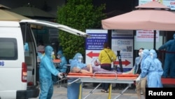 រូបឯកសារ៖ បុគ្គលិកសុខាភិបាលផ្នែកលើកអ្នកជំងឺម្នាក់ដាក់រថយន្តសង្រ្គោះបន្ទាន់ នៅក្រុងដាណាង កាលពីថ្ងៃទី០៤ ខែសីហា​ ឆ្នាំ២០២០។​