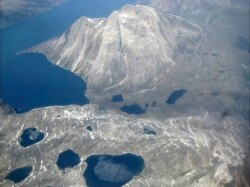 FILE - Melt water lakes are seen on the edge of an ice cap in Nunatarssuk, Greenland, in this aerial view taken on June 22, 2019.