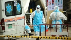 រូបឯកសារ៖ ក្រុមមន្ត្រីសុខាភិបាលស្ថិតក្នុងឯកសណ្ឋានការពារពីការឆ្លងជំងឺកូវីដ១៩ បញ្ជូនអ្នកជំងឺកូវីដ១៩ មកទទួលការព្យាបាលនៅមណ្ឌលព្យាបាល នៅកោះពេជ្រ រាជធានីភ្នំពេញ ថ្ងៃទី១៥ ខែមេសា ឆ្នាំ២០១៩។ (ហ៊ាន សុជាតា/វីអូអេ)