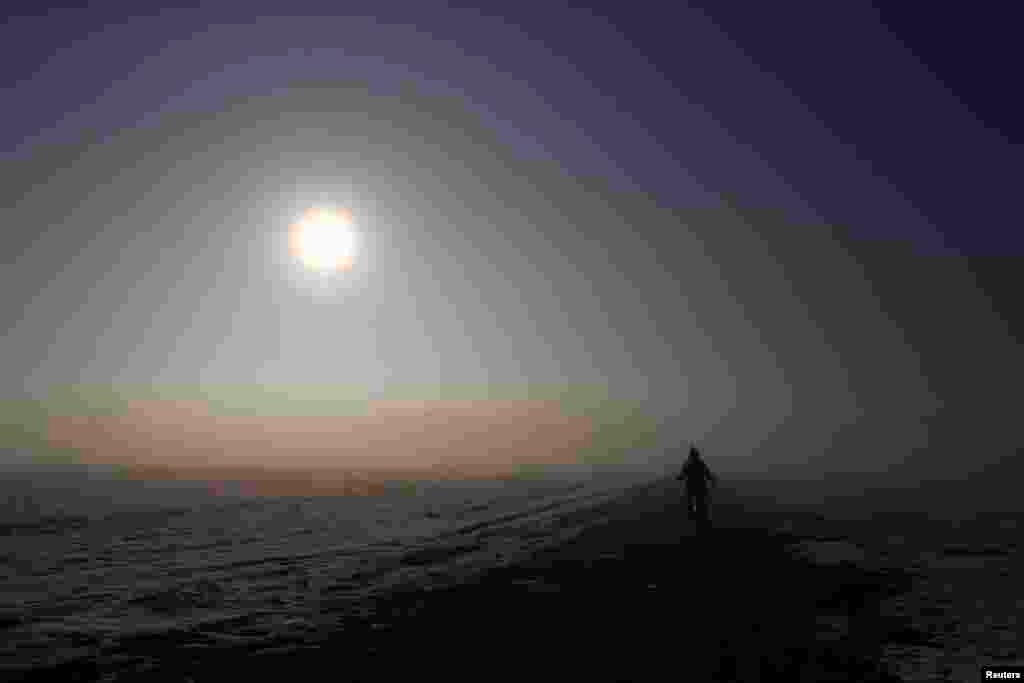 A bicyclist is seen in the early morning hours in Olching westward of Munich, Germany.