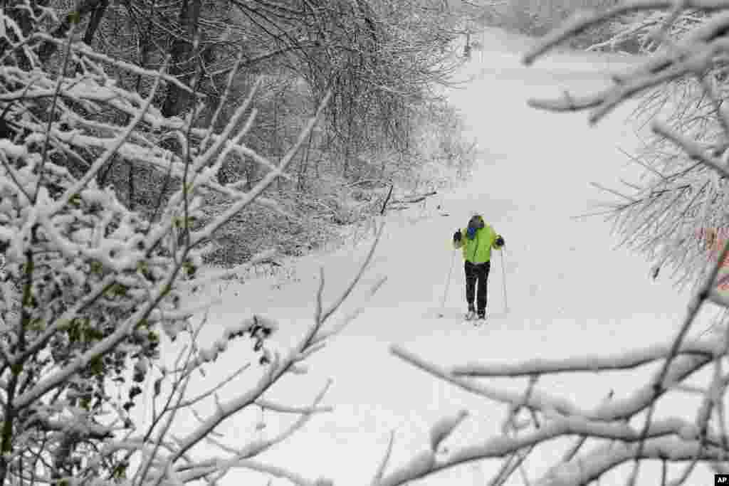 Marilyn Newton uses her cross-country skis as she travels through the snow in Charlotte, North Carolina, Feb. 13, 2014 after a winter storm hit the area.