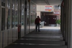 FILE - A man speaks on his phone outside an unemployment office in Madrid, Spain, April 27, 2020.
